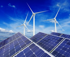 Green alternative energy and environment protection ecology concept - solar battery panels and wind generator turbines against blue sky